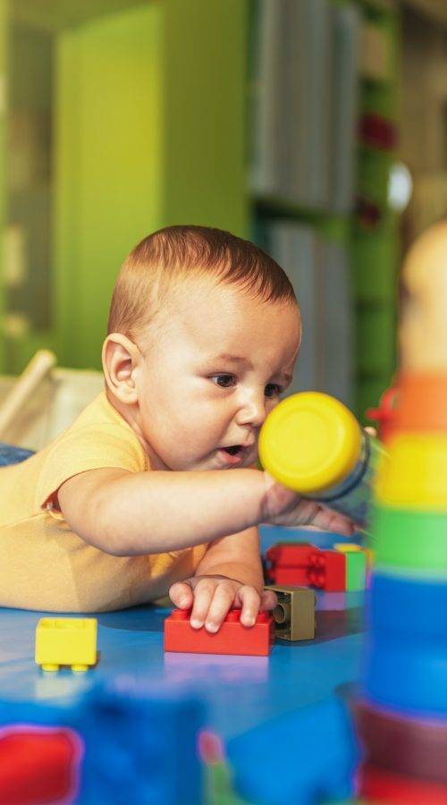 happy-baby-playing-with-toy-blocks-in-the-kindergarten--pyk5vfey3qlbdvfwpxtpll16fos6ytjdyt9pbjrpd4